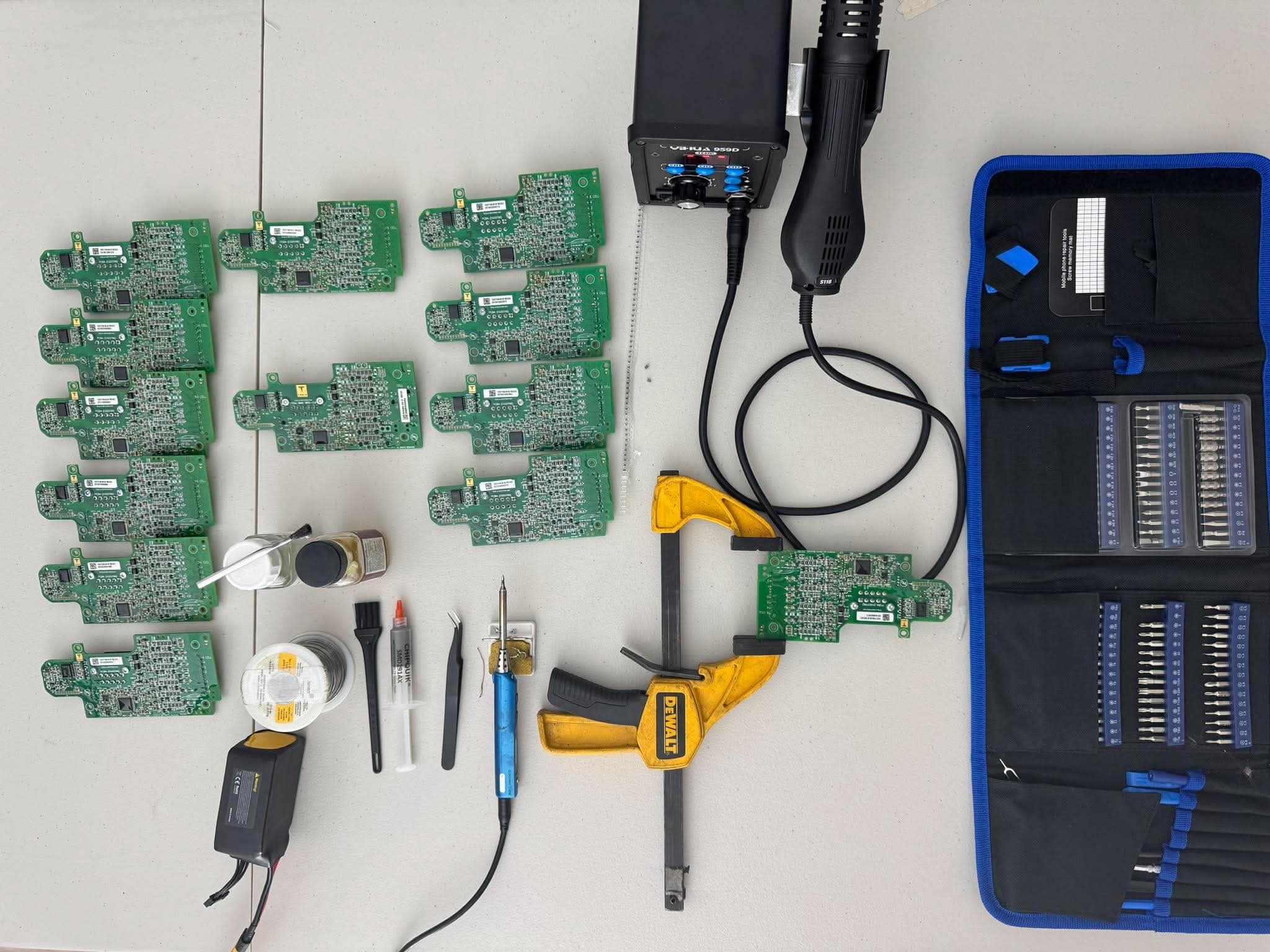 Circuit boards and electronics repair tools arranged on the workbench